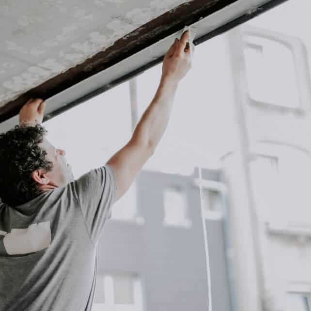 a-young-caucasian-man-repairing-a-window-opening-w-2022-11-15-13-04-41-utc-3x